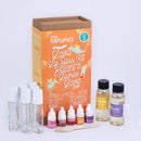 The KISS NATURALS DIY Natural Lava Lip Gloss Kit comes with a box, four small bottles of colored liquids, two clear glass tubes, a dropper, two bottles of all-natural oils, an empty cup, and a wooden stir stick. The orange design on the box emphasizes that this cruelty-free kit includes everything you need for creating your own unique DIY lip gloss.