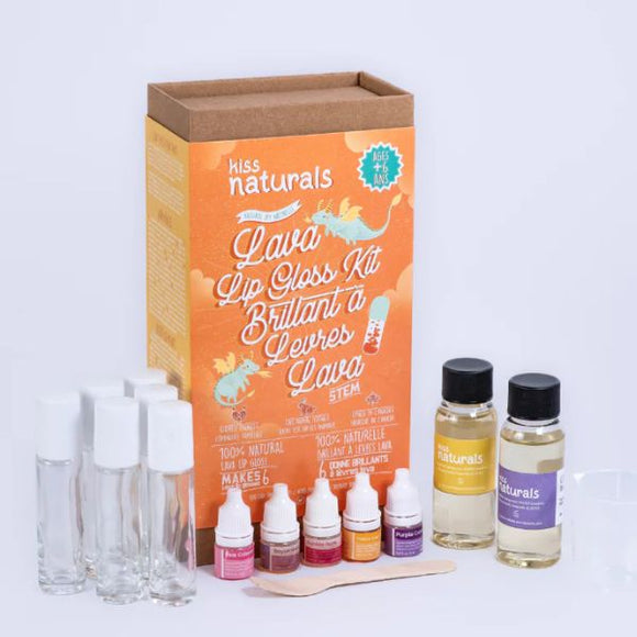 The KISS NATURALS DIY Natural Lava Lip Gloss Kit comes with a box, four small bottles of colored liquids, two clear glass tubes, a dropper, two bottles of all-natural oils, an empty cup, and a wooden stir stick. The orange design on the box emphasizes that this cruelty-free kit includes everything you need for creating your own unique DIY lip gloss.