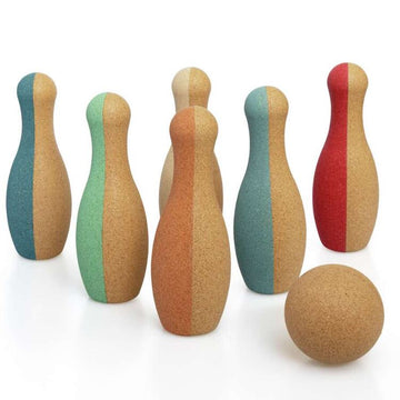 The Korko Little Skittles Bowling Set includes a climate-neutral cork ball and seven striped pins in green, blue, orange, and red. Perfect for enhancing hand-eye coordination on any light surface.