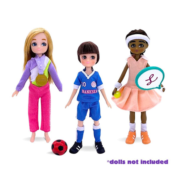 The Lottie Branksea Sports Club Set by Lottie features outfits: a shiny gymnastics leotard with medal, a vibrant soccer uniform with ball, and a sleek tennis outfit with racket. Text reads "dolls not included.