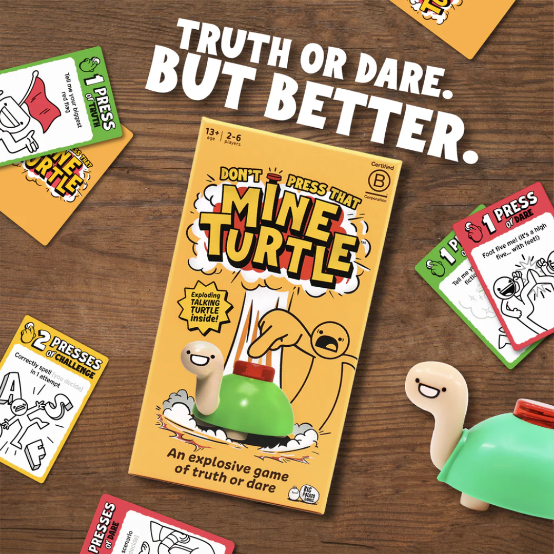 On a wooden surface lies the board game "Don't Press That Mine Turtle," with cards surrounding it. Above, the text states, "Truth or Dare. But Better." A cartoon Mine Turtle from The Toy Shop adds explosive fun with its signature button on its back.