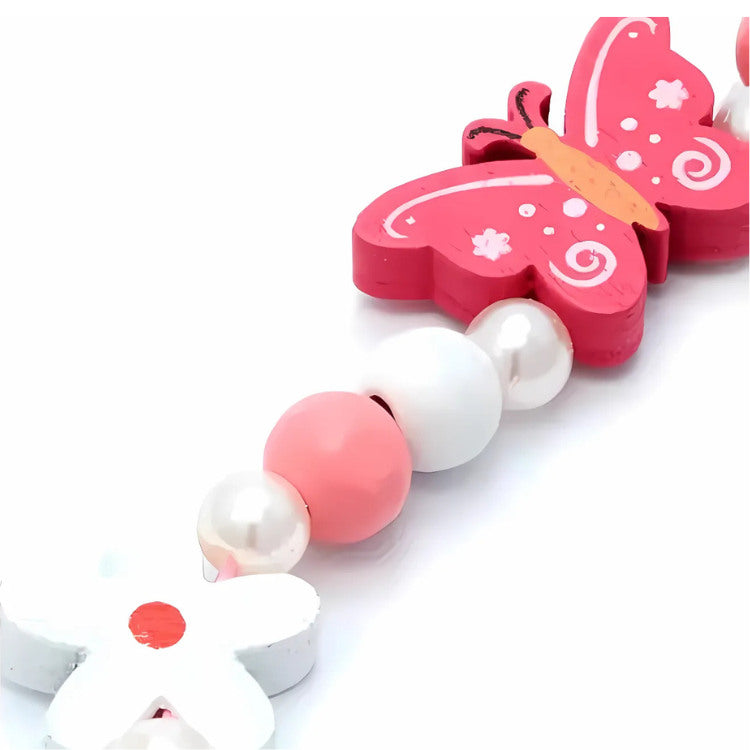 The molly & rose Butterfly Bead Necklace & Bracelet Set features pink and white butterfly and flower charms, complemented by pink beads and a distinctive white flower with a red center. Ideal for decorating party bags or enhancing a pearl bead necklace.