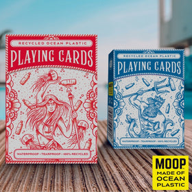Two packs of Ocean Plastic Playing Cards from Big Potato Games, crafted from recycled ocean plastic. The red pack features a mermaid surrounded by ocean waste, while the blue pack displays a king holding a trident. The label "MOOP - Made of Ocean Plastic" at the bottom underscores their eco-friendly design.