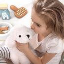 Child holding a plush toy with pet-related items on a white surface