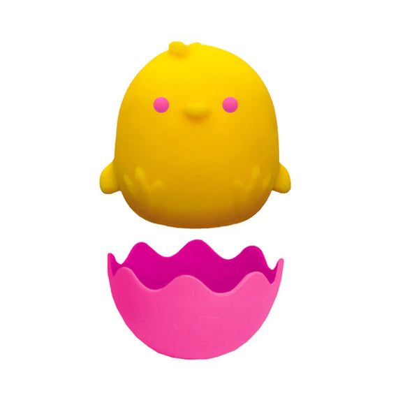 A cute NeeDoh Chicka DeeDoos by Schylling, featuring a yellow chick with pink cheeks and tiny wings, sits atop a cracked pink eggshell base. Its playful design makes it a perfect Easter sensory squish stress reliever.