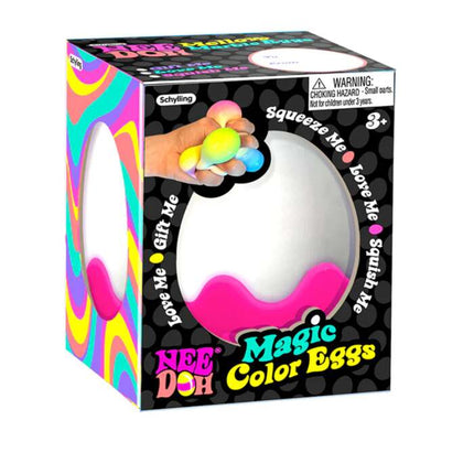 The vibrant packaging of the "NeeDoh Magic Colour Egg" by Schylling serves as both engaging and enjoyable fidget toys. The box features an image of a hand squeezing pastel-colored eggs, surrounded by warnings and playful phrases such as "Love Me" and "Squish Me." These toys are suitable for children aged 3 and older.