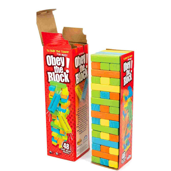 The Outset Media Obey The Block stacking game is shown with its box open, revealing 48 solid wood blocks in green, blue, yellow, and orange neatly stacked next to the packaging—ideal for building a wobbly tower.