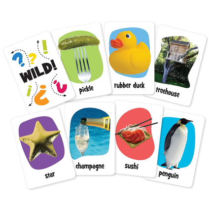 The Pickles To Penguins Travel Game by Outset Cheatwell is a creative card game featuring images like "WILD!", a pickle on a fork, rubber duck, treehouse, starfish, champagne in ice, sushi plate, and penguin. Ideal for sparking creativity through picture-linking fun!.
