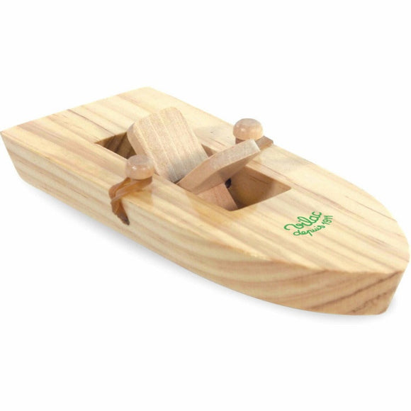 The Vilac Rubber Band Powered Boat is a small wooden toy with a simple design, featuring a flat base, rectangular opening, two rear dowels, and a rubber band mechanism. Made from light-colored wood with charming grain patterns.