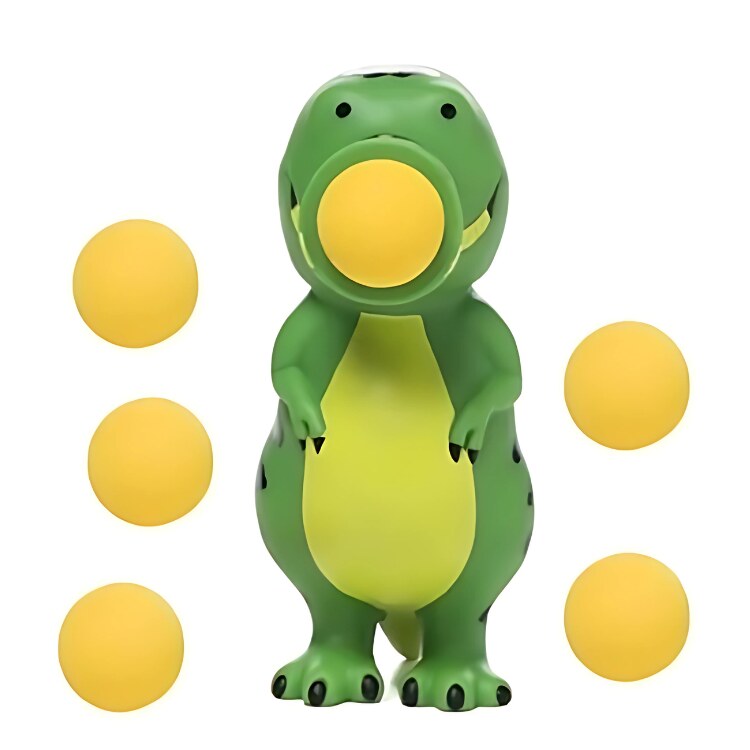 A green and yellow Squeeze Popper: Dino by Cheatwell Games stands upright with a yellow foam ball in its mouth. Additionally, five more yellow balls float around it against a plain white background, making this toy ideal for indoor and outdoor play.