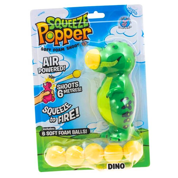 The packaging of the "Squeeze Popper: Dino" toy by Cheatwell Games features a green dinosaur figure equipped with yellow foam balls. Ideal for both indoor and outdoor settings, this air-powered toy can propel the foam balls up to 6 meters. The package comes with 6 foam balls for continuous enjoyment.