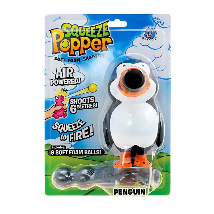 The packaging of the Cheatwell Games "Squeeze Popper: Penguin" toy, showcasing a penguin-shaped soft foam shooter, encourages thrilling play both indoors and outdoors. It highlights air-powered shooting capabilities of up to 6 meters and includes six foam balls, all set against a colorful backdrop featuring clouds and grass.