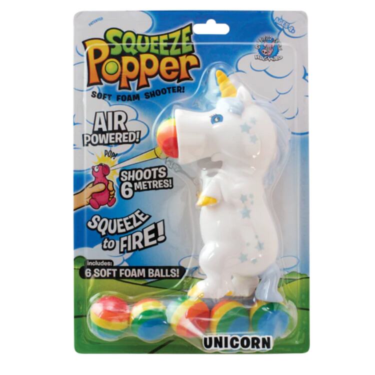 The packaging for the Squeeze Popper: Unicorn White by Cheatwell Games displays a delightful unicorn figure that is predominantly white with a yellow horn. It comes with six vibrant foam balls and prominently features text such as "Air Powered," "Shoots 6 Metres!" and "Squeeze to Fire.