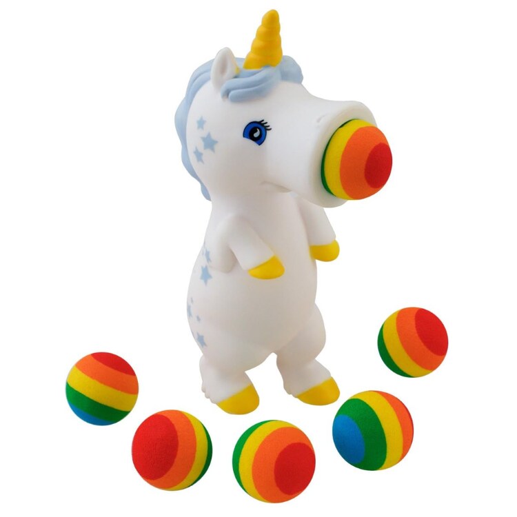 A product from Cheatwell Games, the Squeeze Popper: Unicorn White, is designed with an upright stance, featuring a blue mane and yellow horn. It holds a rainbow-colored foam ball in its mouth and comes with five additional vibrant foam balls, adorned with star patterns on its body.