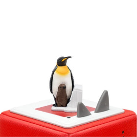 The Tonie - National Geographic - Penguin by Tonies features plastic Emperor penguin and chick figures on a red music box, surrounded by small icebergs and two gray triangular buttons—a charming homage to flightless birds.