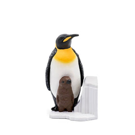 The Tonie - National Geographic - Penguin by Tonies features an emperor penguin with a black head, white belly, and yellow breast beside a brown chick on a white base, set against a plain white background.