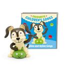 A cute cartoon dog figurine sits with a green toy beside the Tonie - Favourite Children's Songs - Playtime & Action Songs book from Tonies. The cover features the same playful pup surrounded by colorful balls, ideal for bringing joy during playtime and parties.
