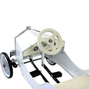 The Vilac - Large Pedal Car - White offers a timeless, vintage look with a white body and beige steering wheel. Ideal for young drivers, it features black pedals, silver detailing, and large black front wheels with silver hubs, all in an open-topped minimalist design.