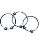Three YUMMIKEYS Yummirings - Stainless Steel Teething Rings feature spherical beads spaced at intervals, arranged in a neat, overlapping manner against a white background. Each ring has subtle design variations with different bead textures, making it an ideal multi-sensory toy for teething gums.