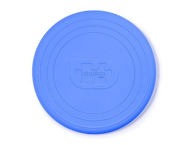 An eco-friendly Foldable Flyers frisbee by The Toy Shop, in ocean blue silicone, features circular grooves and a recessed puzzle piece logo engraved with "BIGJIGS Toys.