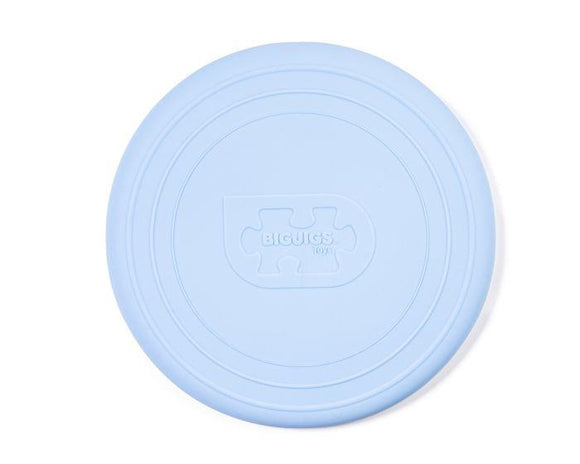 The Toy Shop's Foldable Flyers in powder blue feature embossed text and a puzzle piece design at the center, with concentric edge patterns. This eco-friendly silicone frisbee offers a sustainable way to enjoy playful fun.