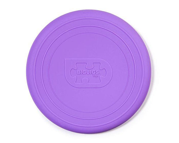 A purple silicone frisbee called "Foldable Flyers" from The Toy Shop features a puzzle piece logo and the words "Bigjigs Toys" embossed in the center, designed as an eco-friendly toy for endless fun.
