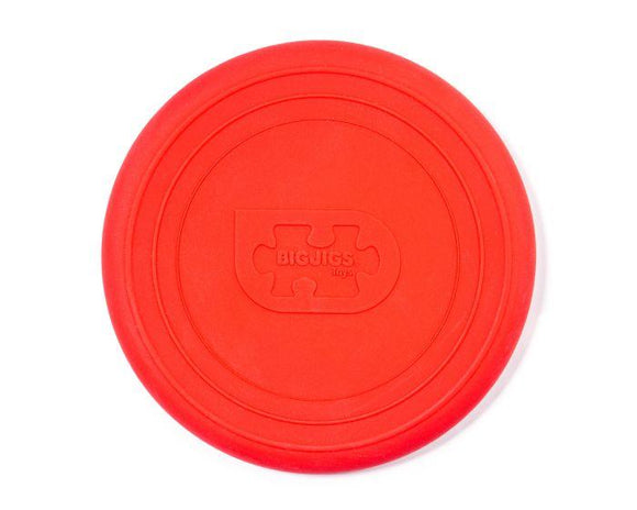 This cherry red silicone Foldable Flyer, branded with a puzzle piece logo and "BIGJIGS Toys," embodies eco-friendly fun for all ages, reflecting a commitment to sustainability.