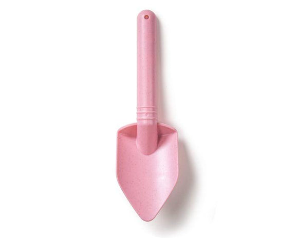 The Toy Shop's Eco Spade is a blush pink garden trowel made from wheat fiber, featuring a smooth handle and pointed blade tip. This eco-friendly toy spade has a rounded end with a small hole for hanging.