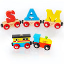 This personalized rail name letter set, featuring wooden train cars spelling "SAM" in vibrant red, blue, and yellow letters, is beautifully complemented by a colorful guard's van and a blue engine adorned with the "BIGJIGS" logo. Crafted by the esteemed BIGJIGS brand, this train set makes a memorable gift against a white backdrop.