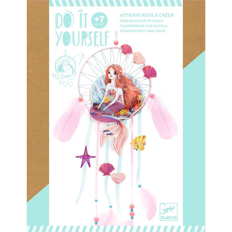 The Djeco DIY Mermaid Dreamcatcher craft kit includes a mermaid dreamcatcher with a mermaid holding a fish, surrounded by seashells, ribbons, and stars. Ideal for ages 7 and up, it features text "Do it yourself" and "Dreamcatcher to create," making it the perfect decorative project.
.