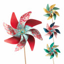 Introduce your space to a touch of whimsy with Djeco's DIY Windmills. This set includes four colorful decorative windmills featuring floral patterns on wooden sticks. One windmill stands out with its predominantly red design, while the others showcase varying shades of green, yellow, and blue complemented by intricate designs. Crafted from FSC-certified paper, these beautiful windmills spin gracefully against a white background.