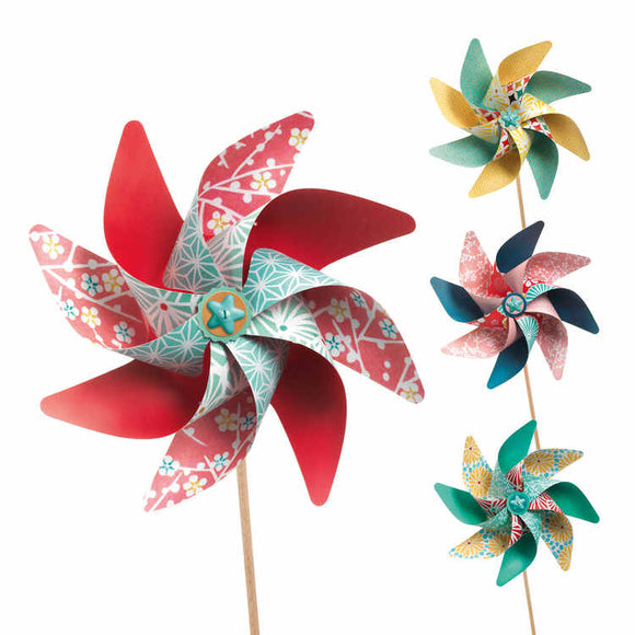 Introduce your space to a touch of whimsy with Djeco's DIY Windmills. This set includes four colorful decorative windmills featuring floral patterns on wooden sticks. One windmill stands out with its predominantly red design, while the others showcase varying shades of green, yellow, and blue complemented by intricate designs. Crafted from FSC-certified paper, these beautiful windmills spin gracefully against a white background.
