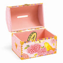 The Djeco Birds Money Box is a charming decorative wooden piggy bank, painted in soft pink with floral patterns and a yellow bird illustration. The inside matches the exterior hue and includes a coin slot on its lid, making it both functional and delightful.