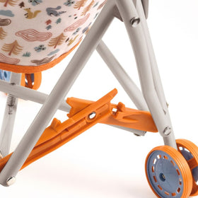 Close-up of a Djeco Stroller Forest reveals its foldable gray metal frame with an orange wheel lock, blue wheels, and a fabric seat ideal for dolls. The seat is adorned with pastel cartoon animals and trees, making it a charming doll accessory. Brand: Djeco.