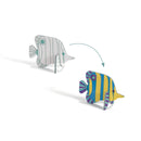 Djeco's "Colour, Assemble & Play Sea-Life" kit includes two FSC certified cardboard fish models: one uncolored with outlined stripes and the other vibrantly decorated in yellow, blue, and purple. An arrow showcases the magic of transforming sea-life through coloring and assembling.