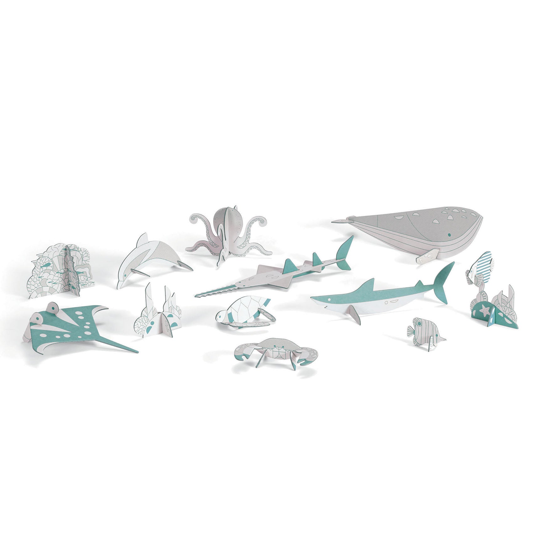 The "Colour, Assemble & Play Sea-Life" kit by Djeco features FSC certified cardboard paper models of a whale, dolphin, octopus, crab, fish, and stingray in teal, gray, and white displayed on a white background.