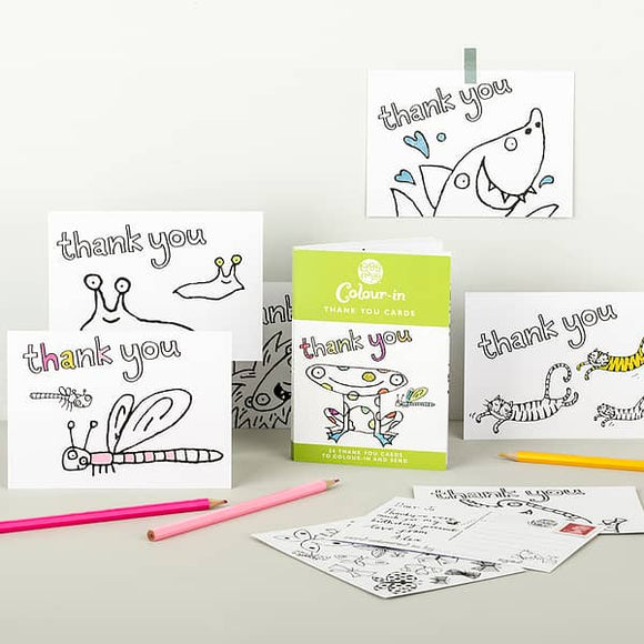 The Eggnog Card Book - Colour-in Thank You Cards offers playful animal designs like a butterfly, snail, and shark. Complete with colored pencils, it is beautifully presented on a light surface.