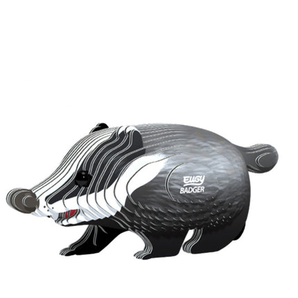 A stylized, cartoonish representation of a badger with "EUGY Badger" adorning its side. Crafted by EUGY with sustainable materials, the design features bold, curving lines in shades of black, gray, and white, giving it a modern and playful look reminiscent of their toy figures.