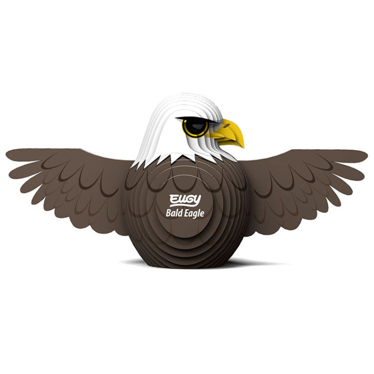 Illustration of a stylized bald eagle with brown wings, a white head, and a yellow beak. The words "Bald Eagle" and "EUGY" are printed on its chest. This eco-friendly EUGY Bald Eagle proudly displays its widespread wings.