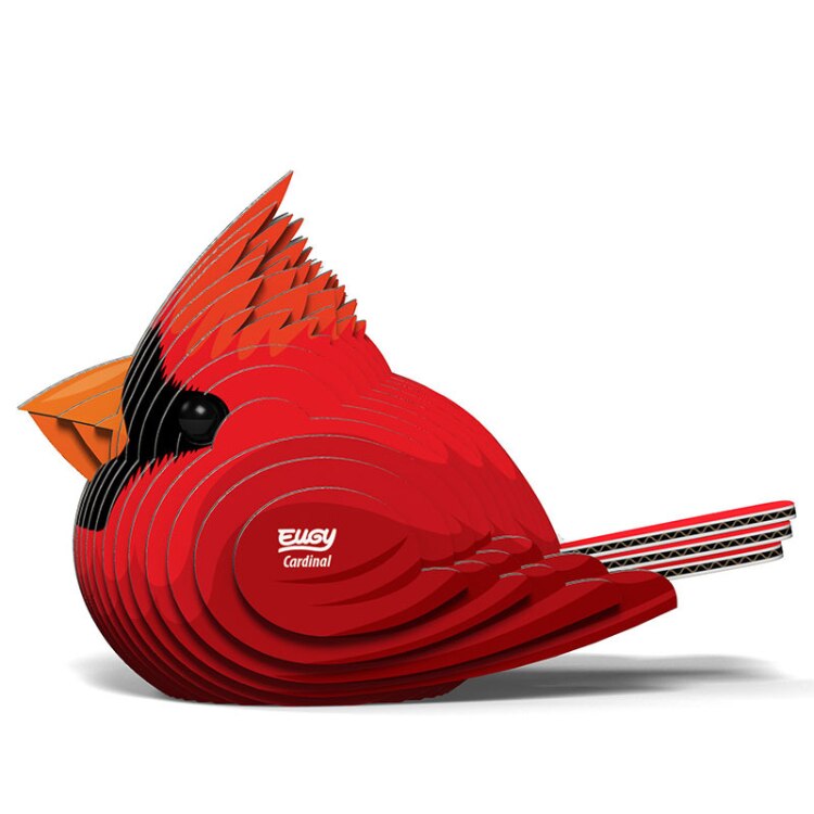 This 3D model of a Northern Cardinal, made from layered paper or cardboard, elegantly displays the words "EUGY Cardinal" on its side. With its vivid red body, black facial markings, and striking orange beak, this songbird is a captivating addition to any collection of EUGY figures.