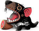 A vibrant, cartoon-style Tasmanian Devil from the EUGY brand, made from biodegradable layered cardboard, features its mouth open wide and holds a cartoon ham with a bone in its paw. This eco-friendly design is labeled "Eugy Tasmanian Devil.
