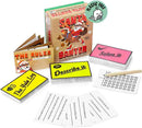 A Christmas game set called "Santa Banter" from The Toy Shop is on display. It includes rule manuals, an imaginative Yule log, entertaining cards with "Describe it" and "Solve it" challenges, rhyming pairs, a pencil for convenience, and challenge cards. The packaging prominently features a “Plastic Free” label alongside a playful octopus graphic.