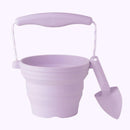 The Scrunch Mini Bucket & Spade by SCRUNCH in pale lavender is ideal for budding gardeners. Its collapsible silicone design includes a flexible handle and ribbed texture, offering practicality and style.