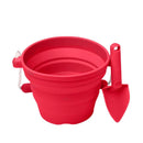 The SCRUNCH Mini Bucket & Spade in Strawberry Red is perfect for little gardeners. Featuring a collapsible silicone bucket with a rope handle and matching shovel, they are designed for easy storage and portability, making them ideal for beach outings or outdoor adventures.