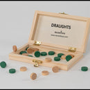 Wooden draughts set with green and brown pieces on a light gray background