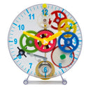 Colour, plastic cogs and parts making up a transparent clock face science kit.