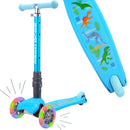 The Teeny 3 Wheel Foldable Scooter, by The Toy Shop, showcases a dinosaur-themed deck with illustrations of T-rex, Stegosaurus, and Triceratops. It includes a sturdy T-bar handle and offers stability with its wide deck. Additionally, the light-up wheels and lean-to-steer design provide extra fun on every ride.
