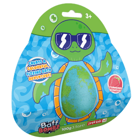 Green and blue egg-shaped bath bomb surrounded by turtle-shaped card packaging.