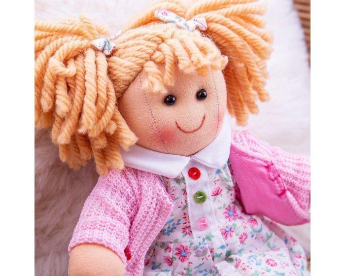 Image of Poppy ragdoll with her removable dress and cardigan beside her.