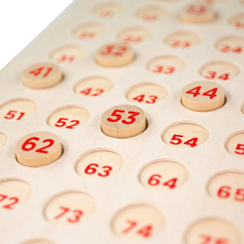 Close-up of numbered pieces on the wooden bingo game